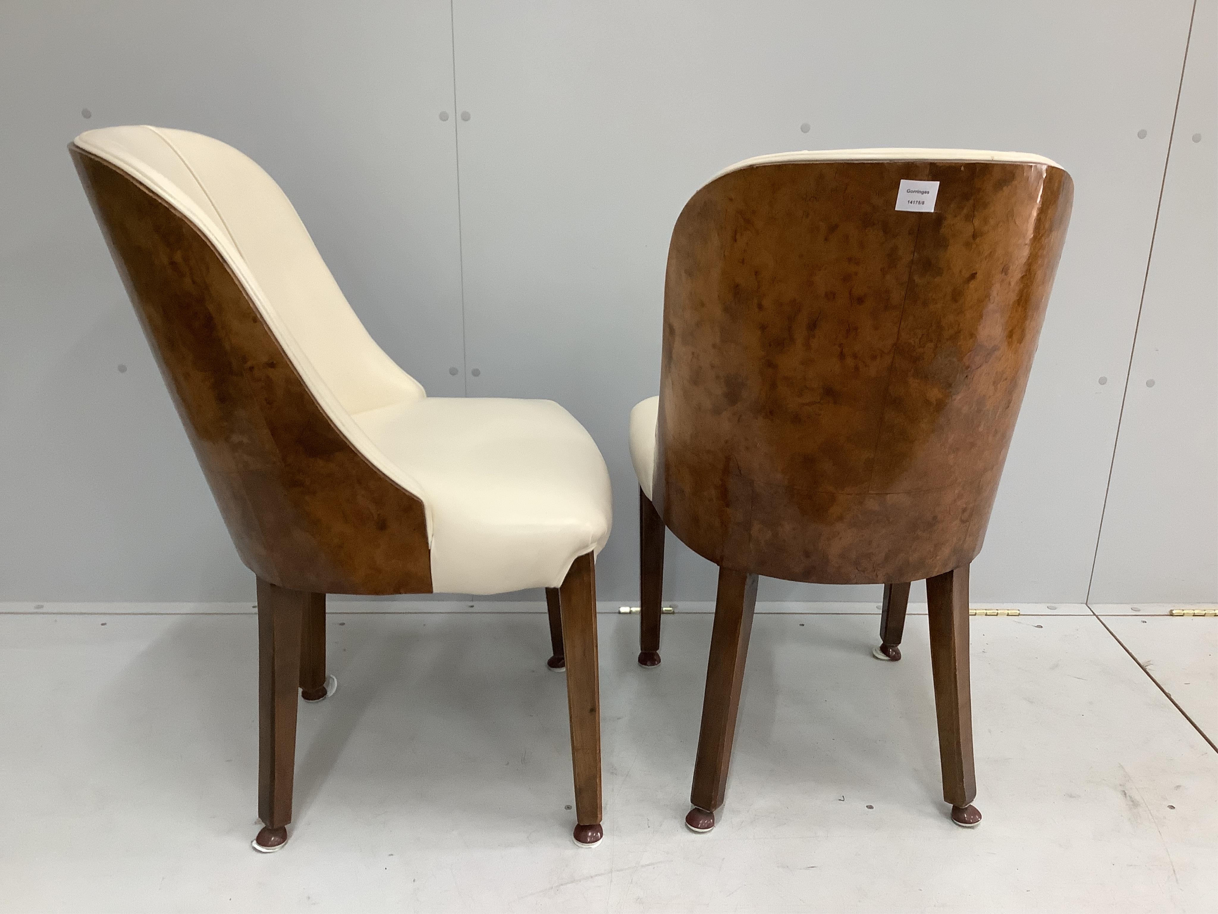 A pair of Art Deco burr walnut and ivory leather chairs